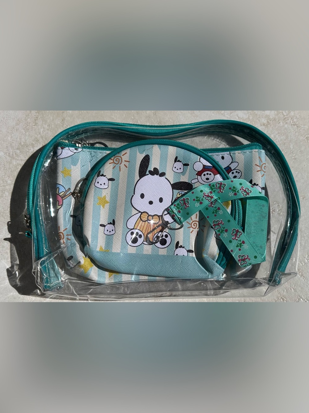 Sanrio Pochacco set of makeup bags and a small lanyard.